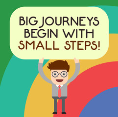 Handwriting text writing Big Journeys Begin With Small Steps. Concept meaning One step at a time to reach your goals Man Standing Holding Above his Head Blank Rectangular Colored Board