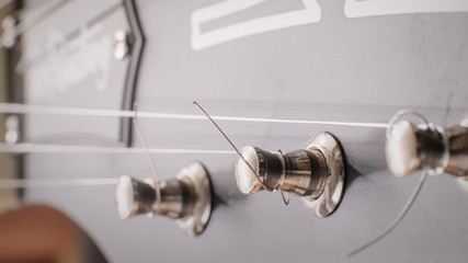 acoustic guitar head with chrome pegs and strings , soft focus, 