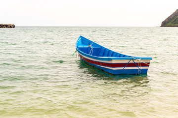 Naklejka na ściany i meble lonely boat in the ocean open water lost rowing boat fishing asia