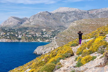 Fototapeta na wymiar Young woman enjoying beautiful view. Kalymnos Island, Greece.
