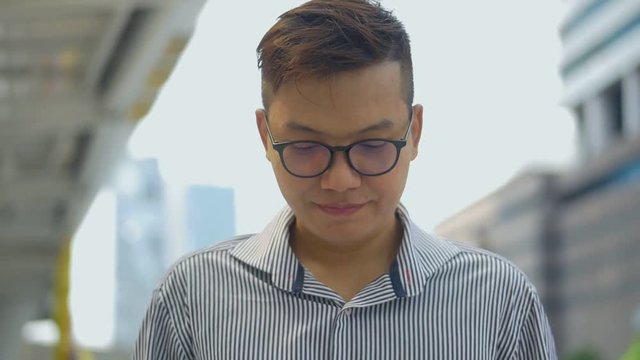 Portrait asian businessman standing texting with friend on smartphone at urban city background, Searching for social media.
