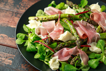 Grilled Asparagus, parma ham salad with mozzarella cheese and green vegetables
