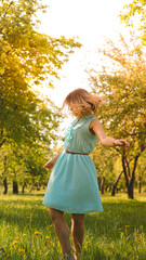 Spring Girl enjoying nature. Beautiful Young Woman Outdoors. Healthy Girl in the Green Park. Sunny day