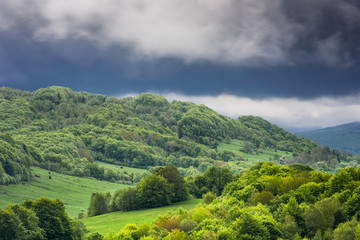 Stormy weather with dramatic rainy clouds over green peaks in Carpathian Mountains, Bieszczady,Poland