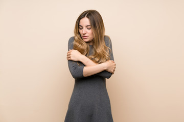 Young woman over isolated background freezing