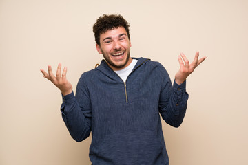 Fototapeta premium Man with curly hair over isolated wall smiling a lot
