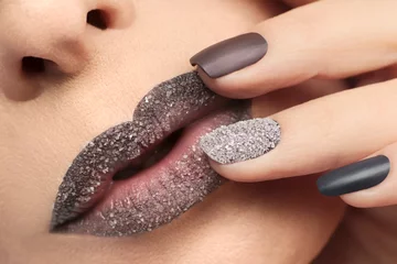 Wandaufkleber Maroon chocolate lips makeup with grains of white sand and multi-colored manicure with different nails from oval to rectangular. © marigo