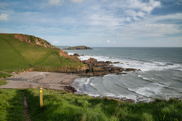 Stunning late evening Spring landscape image of Ayrmer Cove on Devon coastline in England