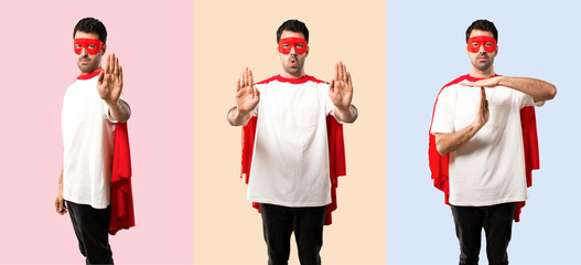 Set of Superhero man with mask and red cape making stop gesture with her hand for disappointed with...