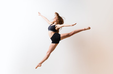 Young dance girl over isolated white wall.