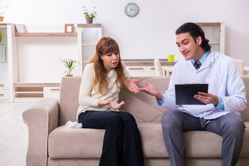Young female patient discussing with male psychologist personal 