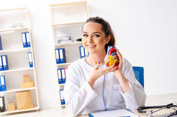 Young female doctor cardiologist sitting at the hospital 