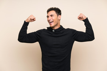 Handsome man over isolated background celebrating a victory