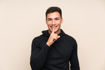 Handsome man over isolated background doing silence gesture