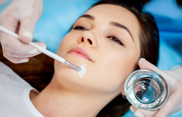 Cosmetic procedure for the face. The procedure of applying the medicine on the face of a beautiful...