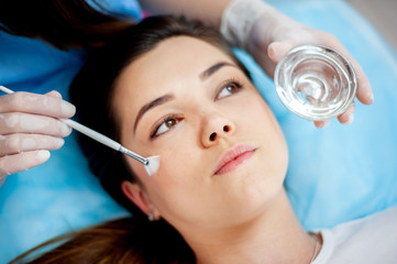 Cosmetic procedure for the face. The procedure of applying the medicine on the face of a beautiful woman. comet clinic