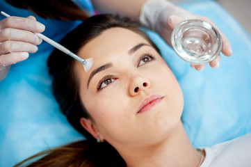 Cosmetic procedure for the face. The procedure of applying the medicine on the face of a beautiful woman. comet clinic