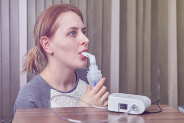 Process of inhalation for woman with asthma.
