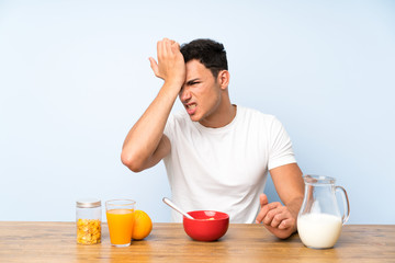 Handsome man in having breakfast having doubts with confuse face expression