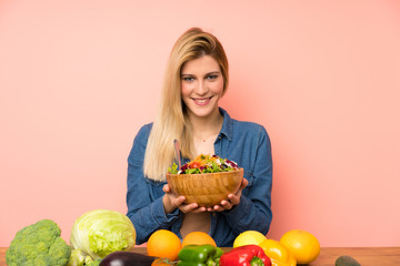 Young blonde woman with salad