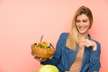 Young blonde woman with salad