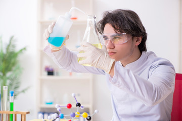 Young male biochemist working in the lab 