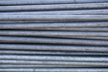 Rows of steel bar storage and stacking in the warehouse for industrial construction.