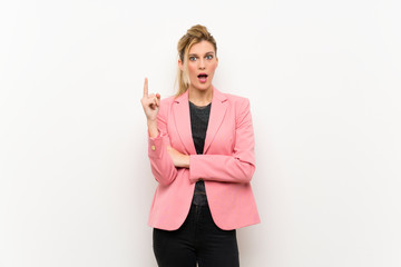 Young blonde woman with pink suit thinking an idea pointing the finger up