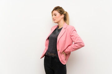 Young blonde woman with pink suit suffering from backache for having made an effort