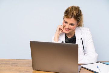 Blonde doctor woman with her laptop