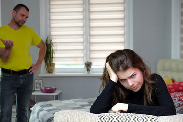 Photograph of problems, conflict of disgruntled, swearing father and brunette girl with long dark...