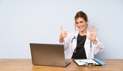 Blonde doctor woman counting six with fingers