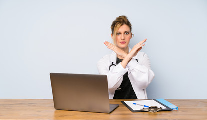 Blonde doctor woman making NO gesture