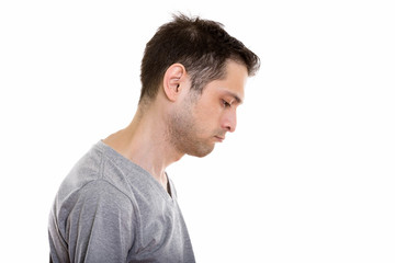 Profile view of sad young man looking down