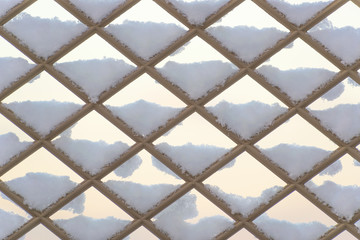 Fence covered in snow, pattern winter background