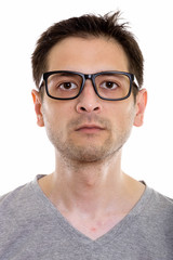 Fototapeta premium Face of young man wearing eyeglasses and looking at camera