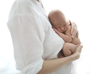 Mom and baby, newborn sleeping in mother hands