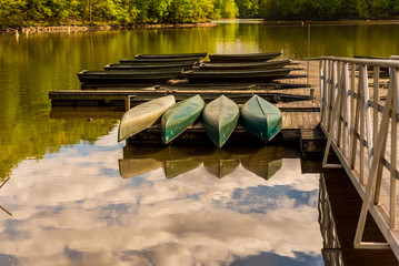 Canoes upside down on a dock on a lake