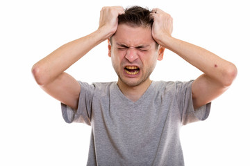 Naklejka premium Studio shot of angry young man pulling his hair
