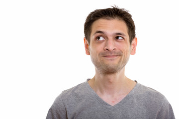 Fototapeta premium Studio shot of young man thinking while looking up