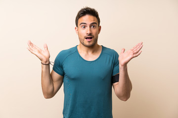 Fototapeta premium Handsome sport man over isolated background with shocked facial expression