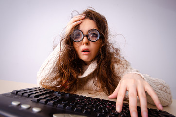 Funny nerd girl working on computer