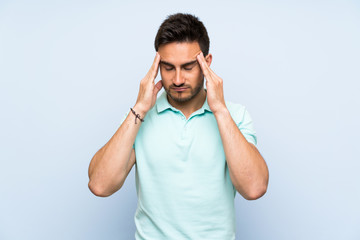 Fototapeta premium Handsome young man over isolated background with headache