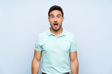 Handsome young man over isolated background with surprise facial expression