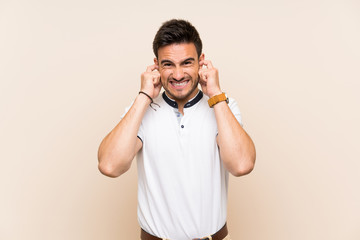 Handsome young man over isolated background frustrated and covering ears