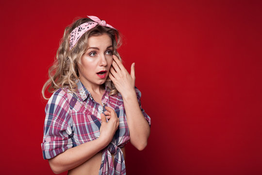 sexy girl posing in pin-up style on red background