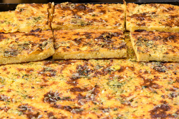 Freshly cooked traditional sweet cheese pie in display for sale at a weekend street food market