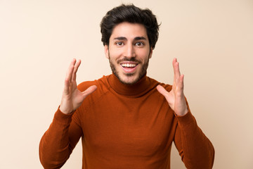 Naklejka premium Handsome over isolated wall with surprise and shocked facial expression