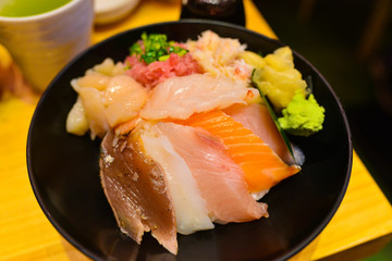 Japanese rice bowl with sashimi seafood on top