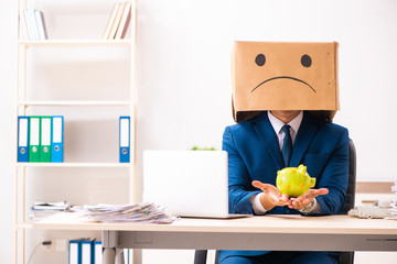 Unhappy man employee with box instead of his head 
